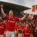 Wrexham AFC viert promotie naar de Championship met spelers en fans op het veld